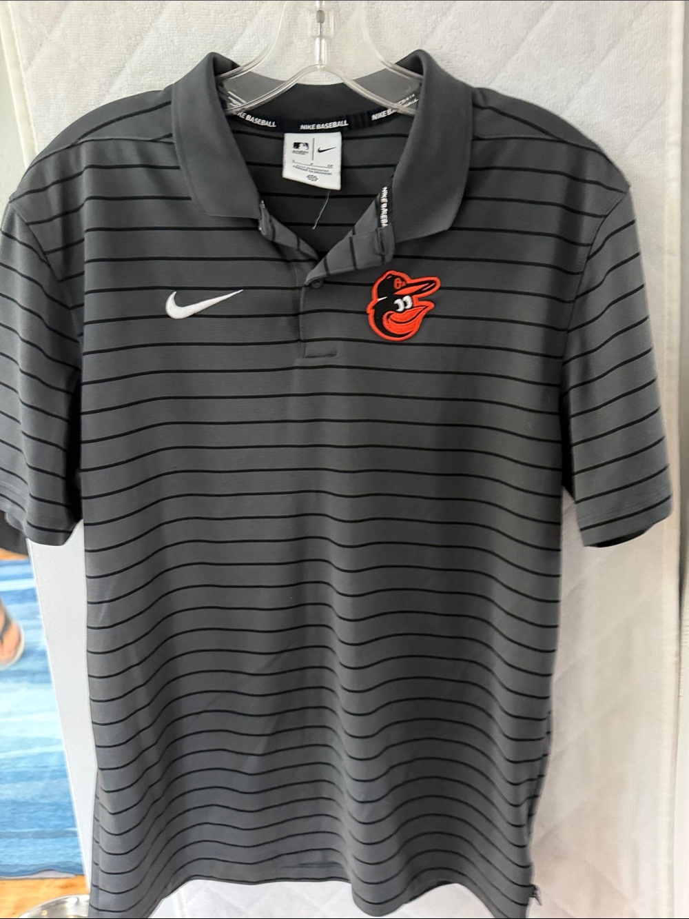 Nike Men’s Gray Striped Polo with Orange Orioles Logo
